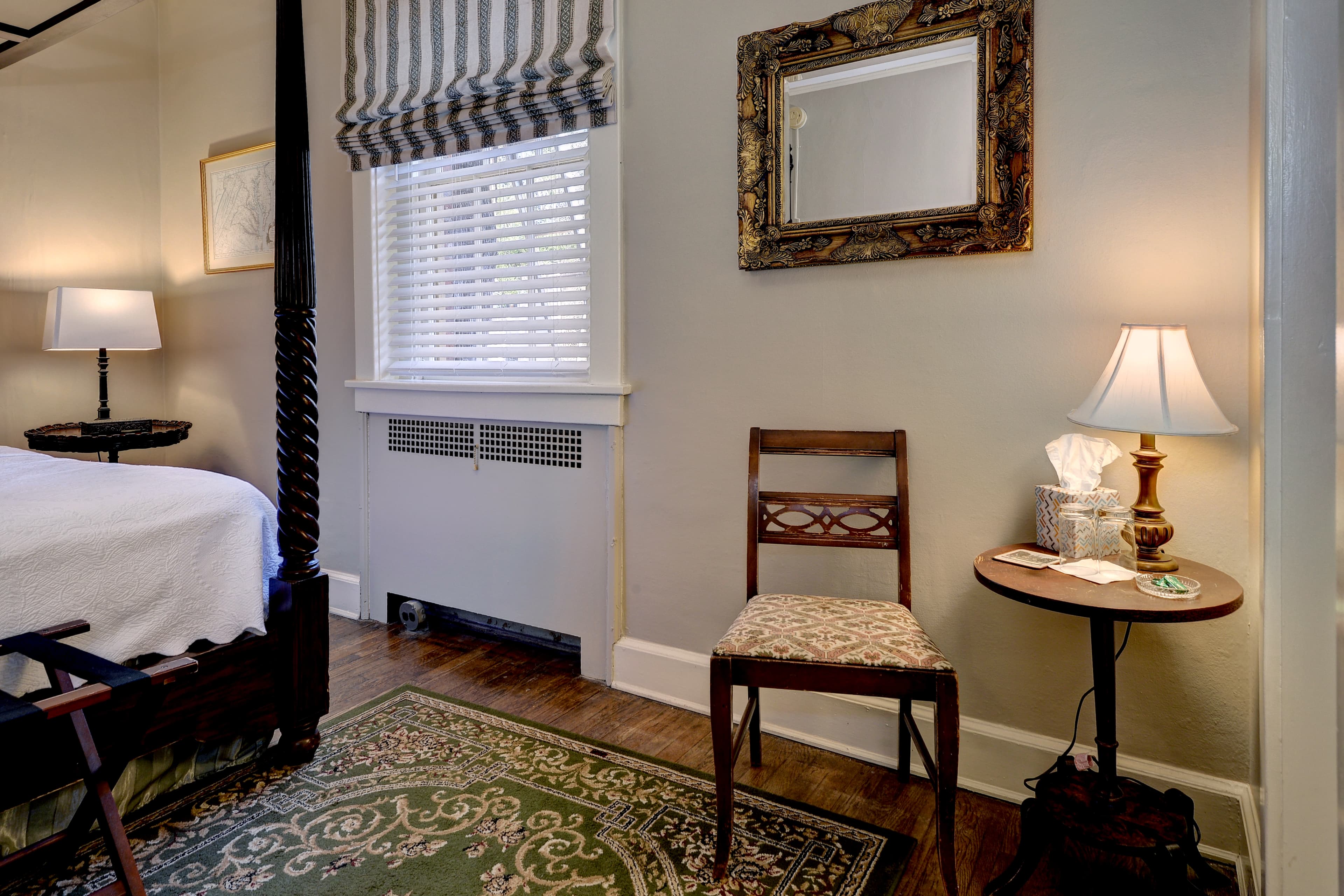 Bathroom with white tub and toilet and small decorative black and white floor tiles